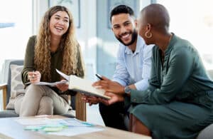 Happy business people smile during a planning meeting in a startup marketing agency office Diversity, collaboration and teamwork in a healthy work environment in an international advertising company