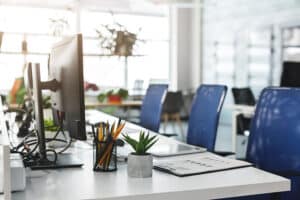 empty modern office space with white tables and blue chairs, simplifying hiring processes